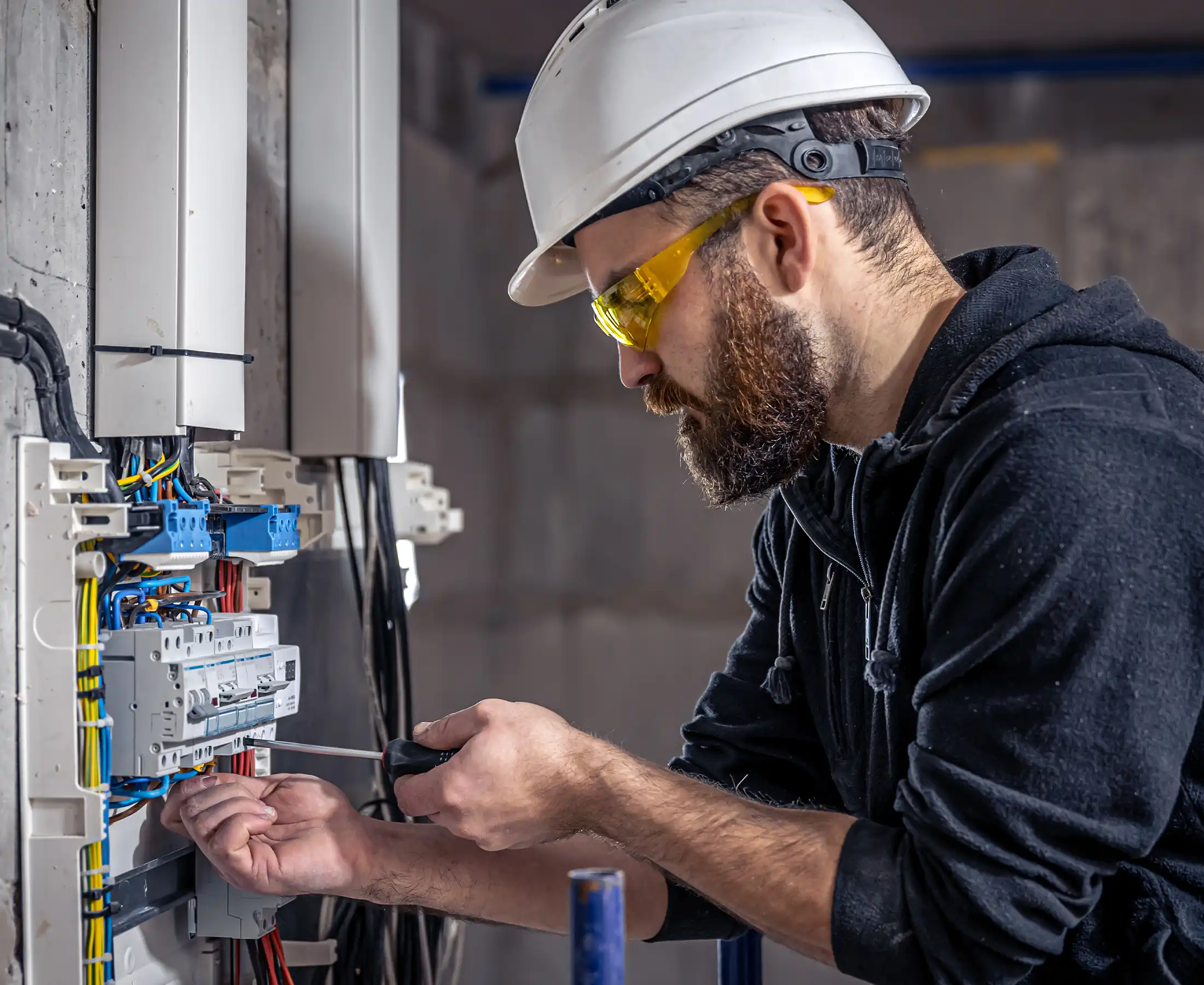 male electrician works in a switchboard