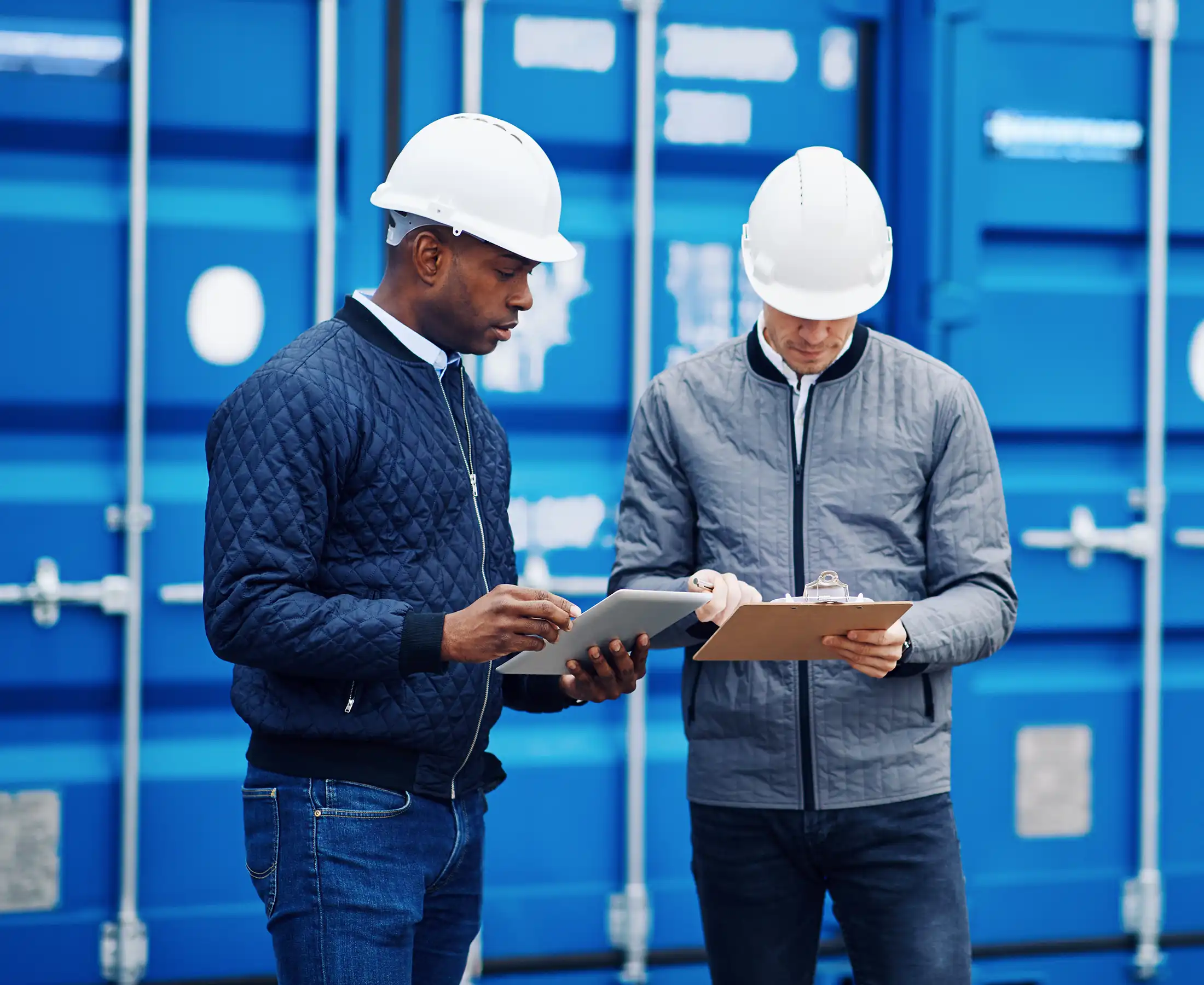 Two engineers tracking containers in a freigh yard