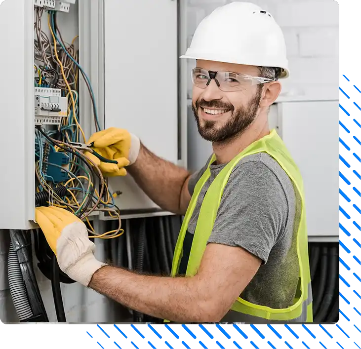 smiling handsome electrician repairing