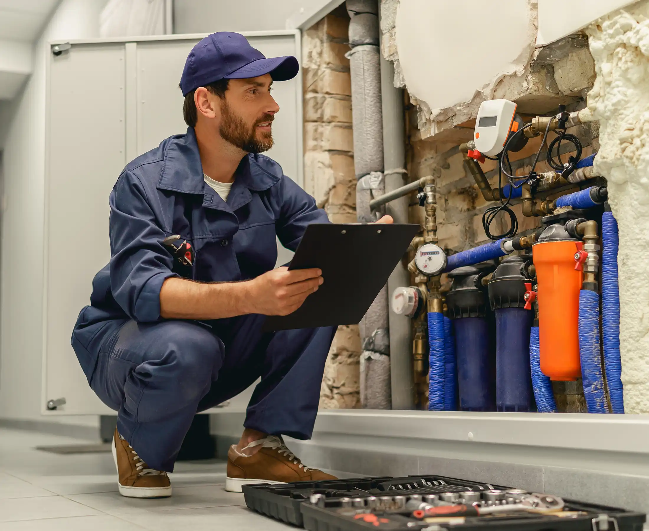 Male plumber diagnoses pipes