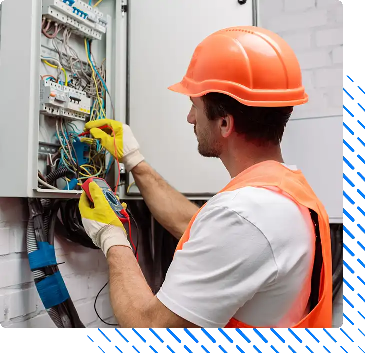 electrician in hardhat and gloves holding multimeter electrician in hardhat and gloves holding multimeter