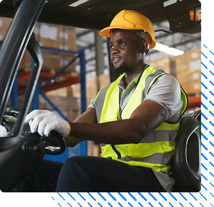 male warehouse worker in safety vest and helmet driving male warehouse worker in safety vest and helmet driving